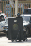 Armed Guard Behind Shield